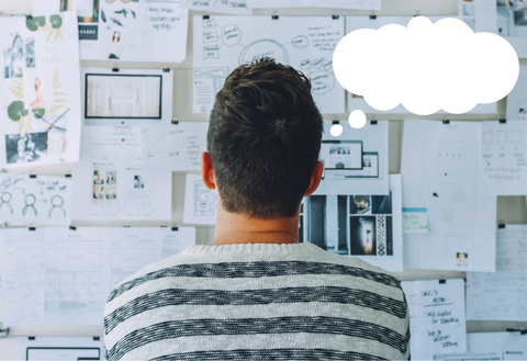 Person looking at bulletin board with thought bubble